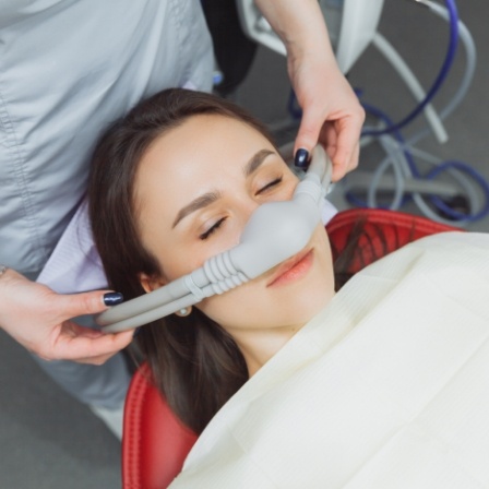 Dental patient with nitrous oxide mask over her nose