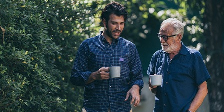 A senior father chatting with his adult son