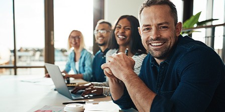 Man smiling at work with dental implants 