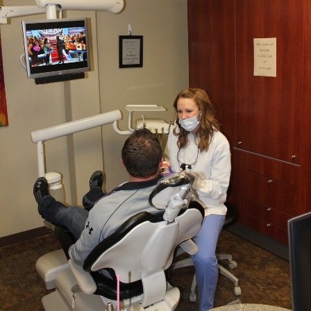 Dental team member talking with a patient