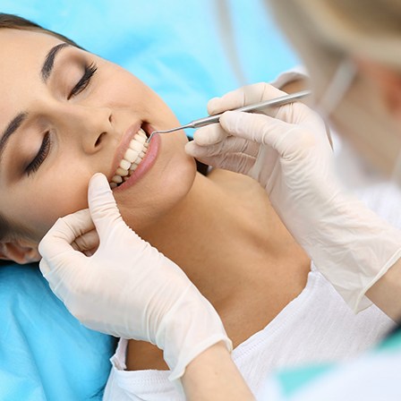 Dentist examining woman’s mouth