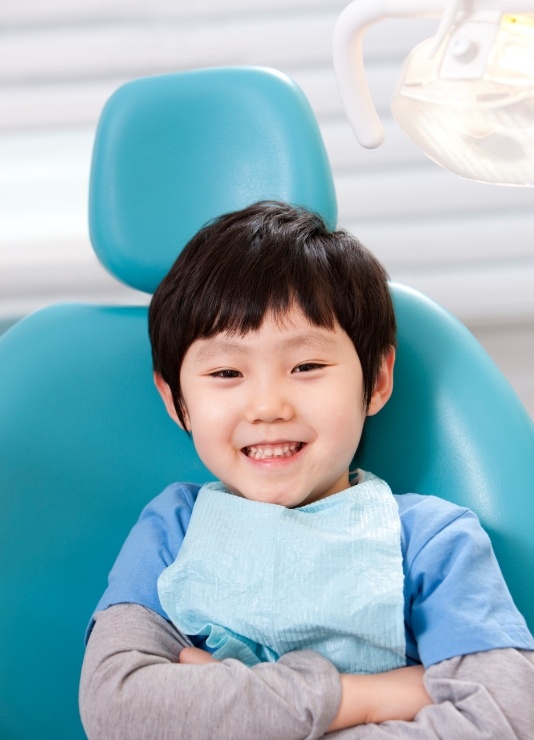 Young boy smiling in dental chair