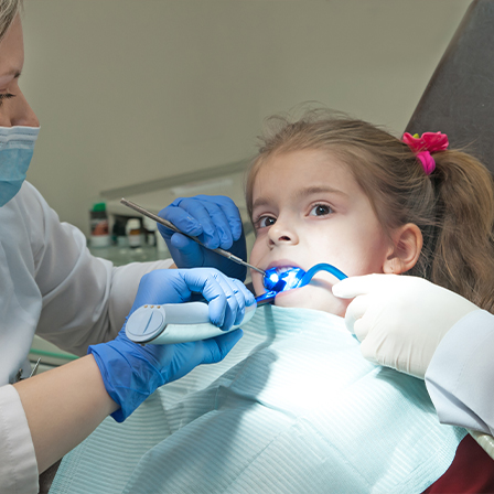 Young girl receiving dental treatment