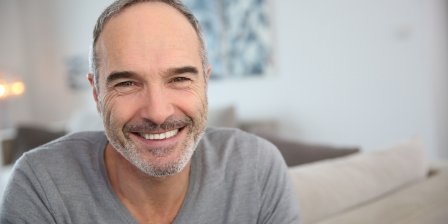 Smiling man in gray sweater