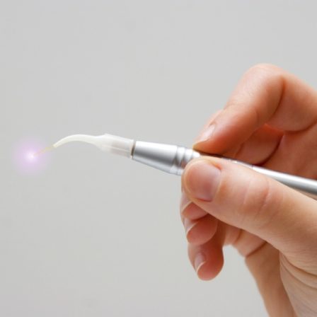 Hand holding a dental laser device