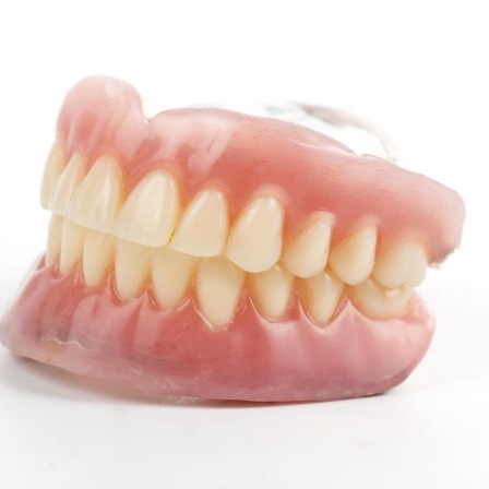 Set of dentures on white background