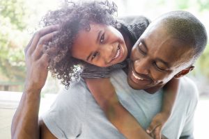 father and daughter smiling