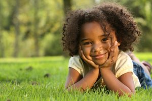 young girl curly hair smiling