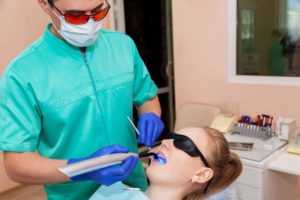 Dentist working with ultraviolet lamp