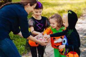 group of kids getting Halloween candy 