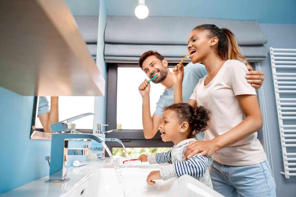 Family brushing their teeth