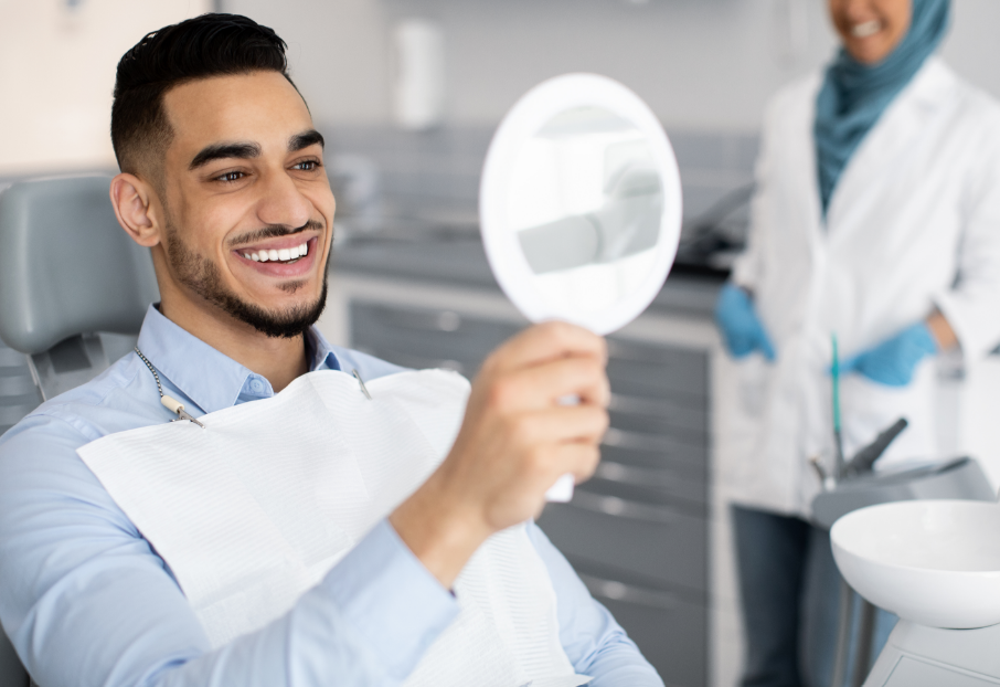 Patient admiring veneers in mirror